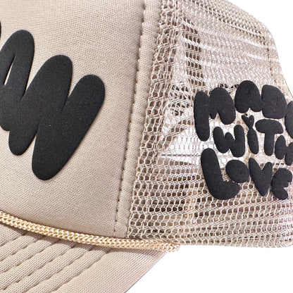 Loveville “H❤️MAN” Trucker Hat – Tan